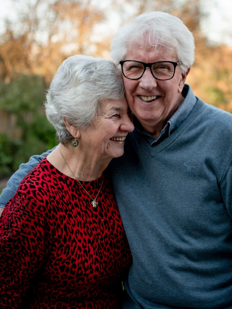 elderly couple embraces