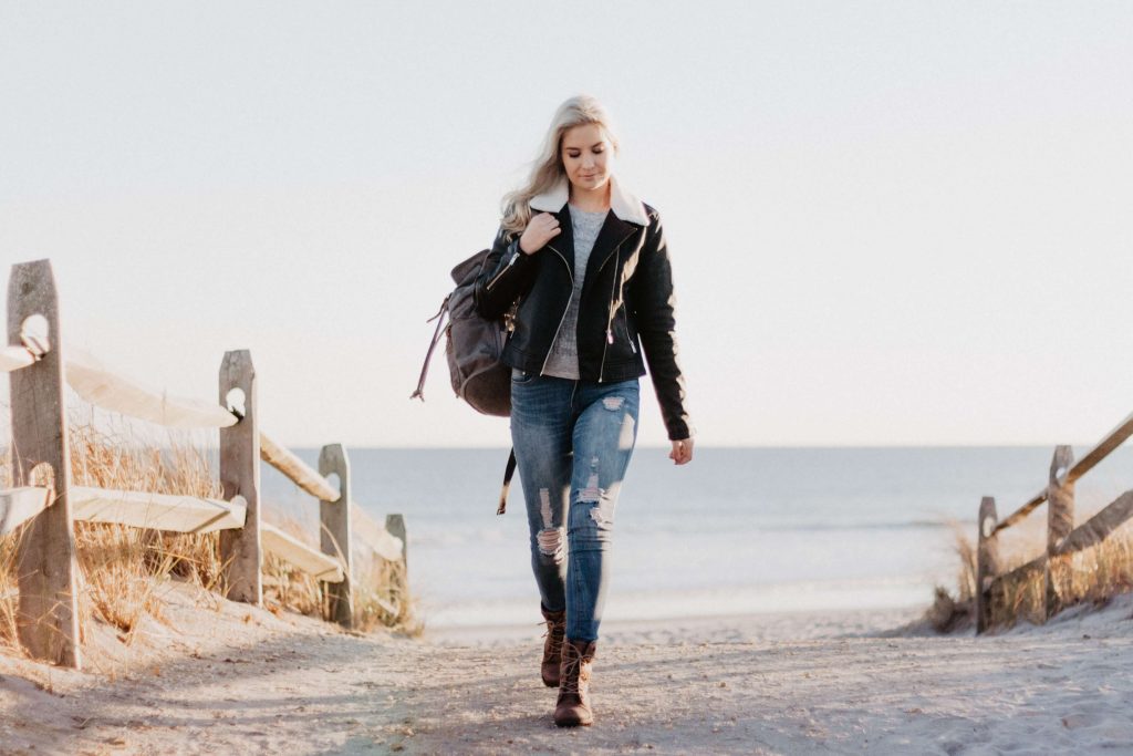 young adult walking with backpack